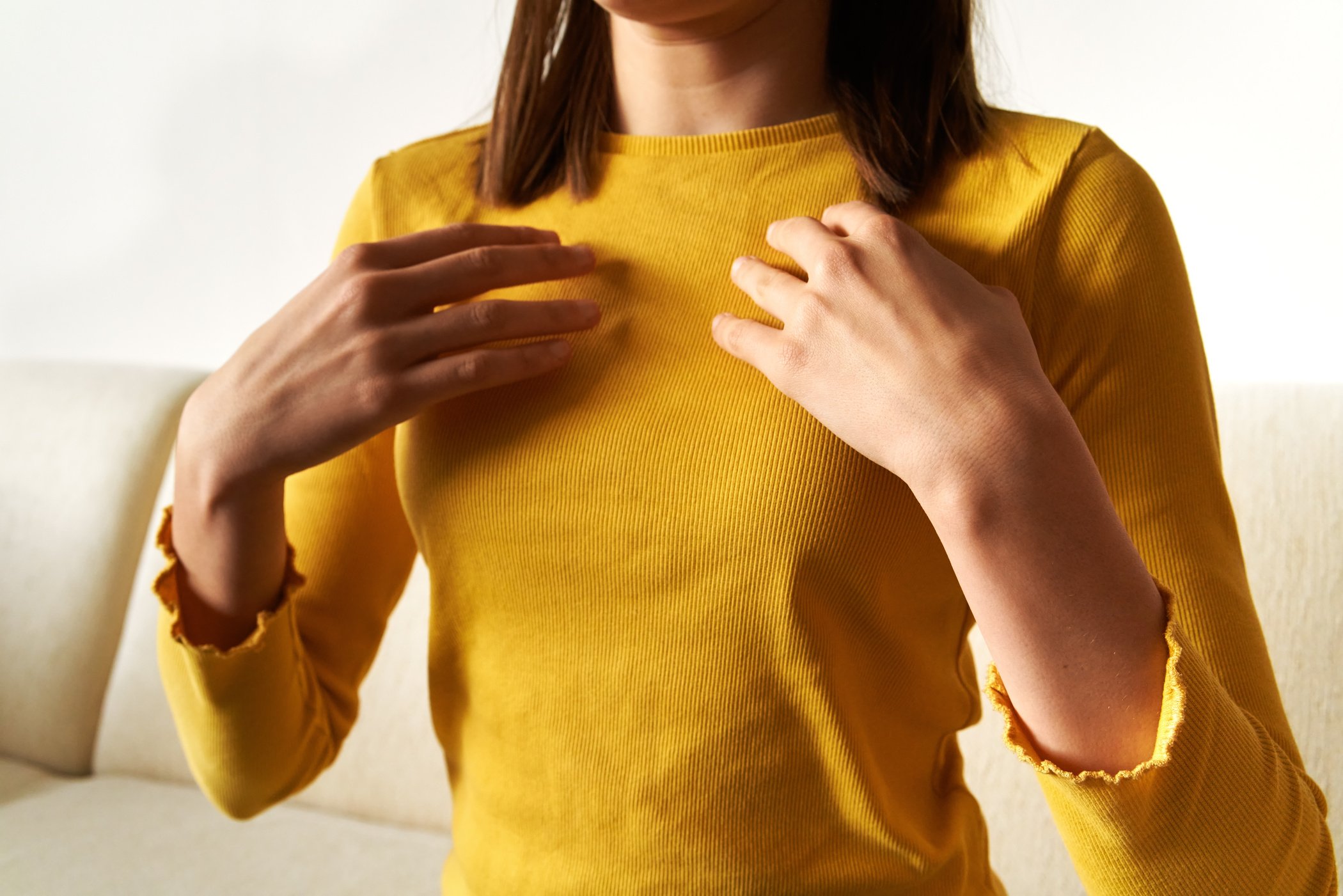 Teenager practicing EFT tapping - emotional freedom technique, tapping on the collarbone point